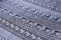 Close-up of gray printed rayon fabric with repeating folk geometric pattern
