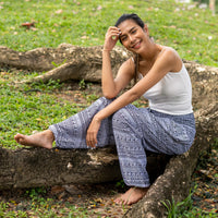 Gray printed rayon pants with draped relaxed legs and ankle cuffs