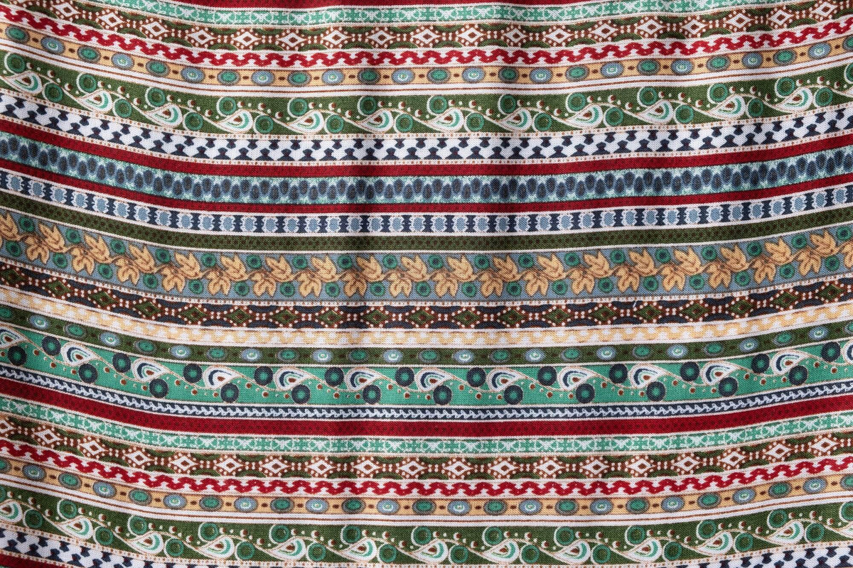 Multicolor patterned rayon fabric with repeating border stripes