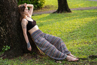 Multicolor patterned rayon pants with wide legs and elastic waist, laid-out side view