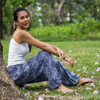 Dark blue paisley print flow pants with flowing wide legs and gathered hem