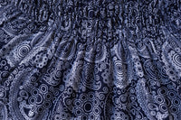 Close-up of dark blue fabric with white paisley pattern for flow pants