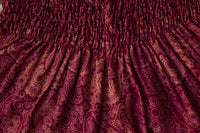 Burgundy paisley flow pants fabric close-up with ruched elastic waistband