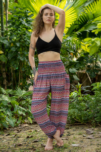 Red rayon harem pants with multicolor patterned print and elastic waistband