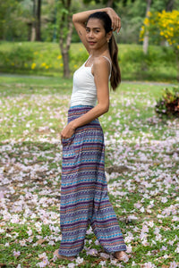 Multicolor patterned rayon pants, wide-leg cut with blue base and stripe motifs.