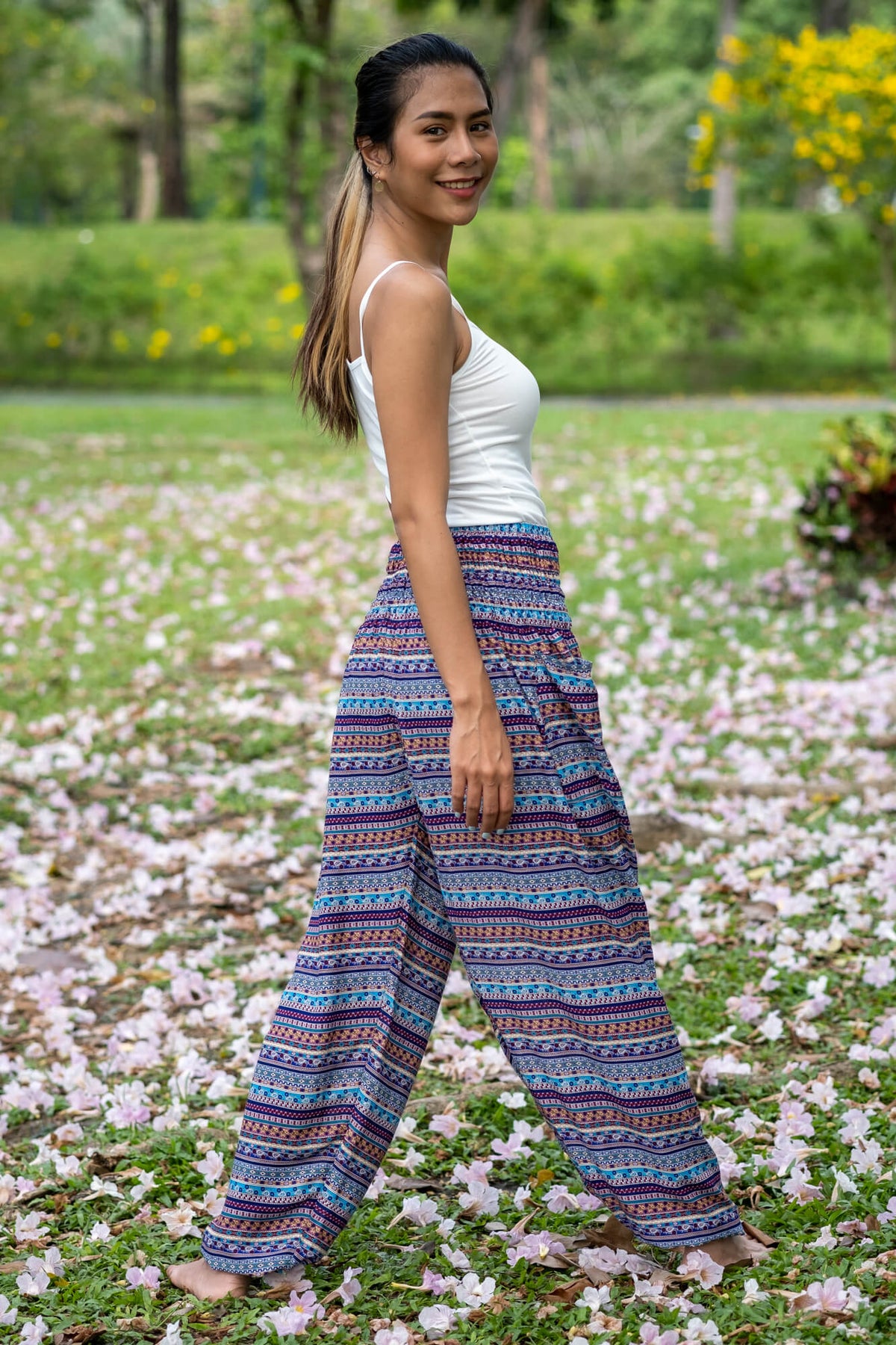 Multicolor rayon wide-leg pants with blue base and repeating stripe and dot pattern.
