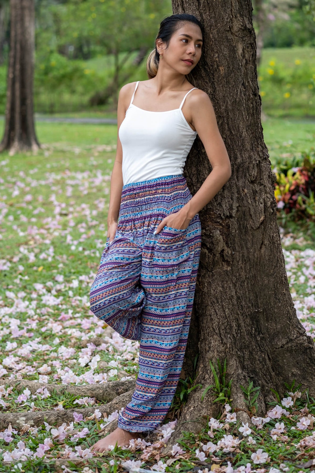 Multicolor patterned rayon pants with wide-leg drape and blue stripe design.