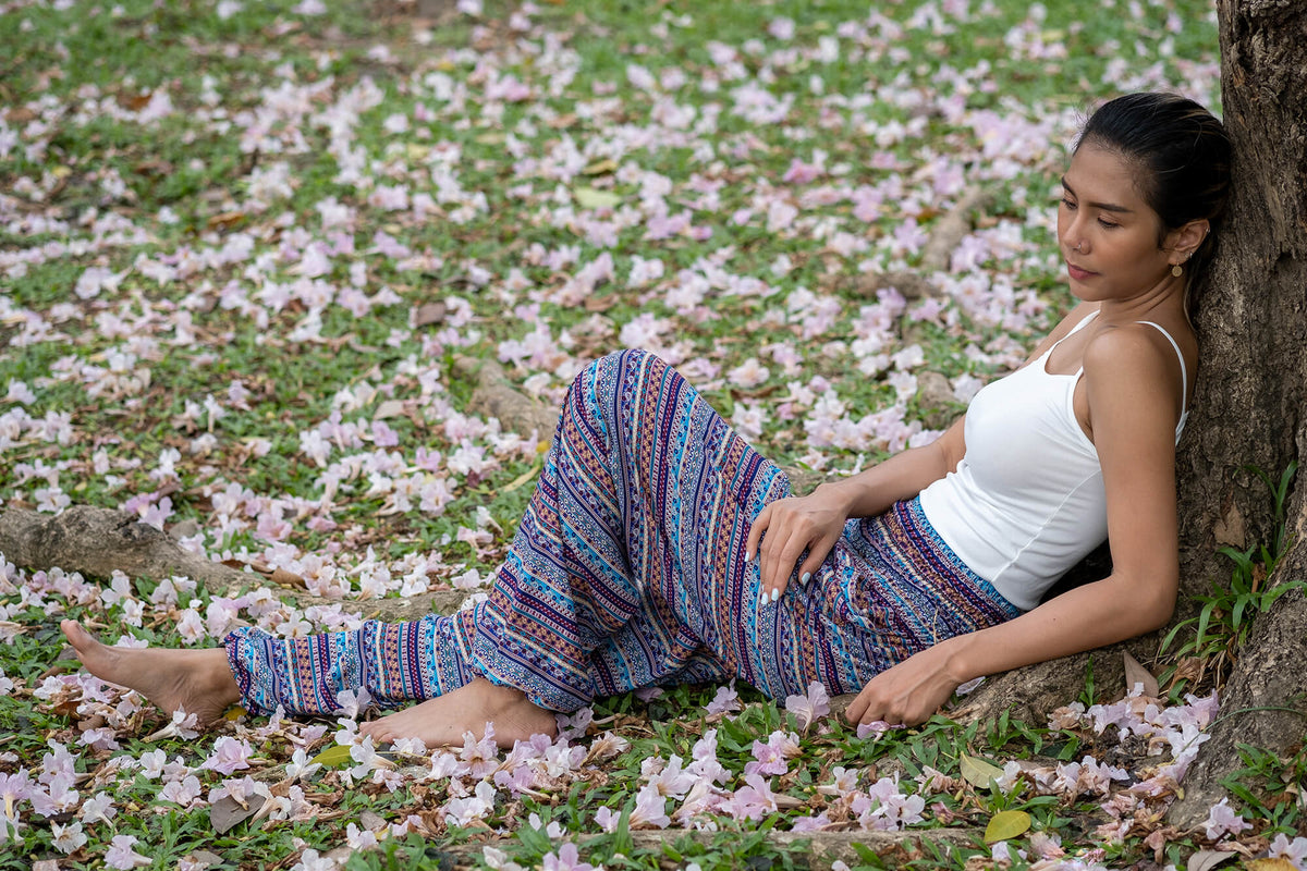 Multicolor patterned rayon pants with loose wide-leg fit and blue stripe print.
